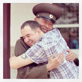 Fellow traveler and Citizen Diplomat to North Korea, Michael Bassett, hugging a 1st Lieutenant (상위) of the KPA.  For more photos by Michael Bassett, click here.